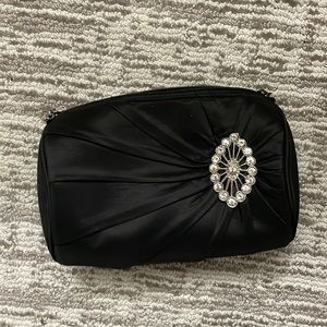 Black satin clutch with rhinestone broach detail
